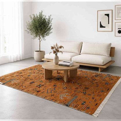Tapis Akhnif orange rouille à symboles berbères et pompons
